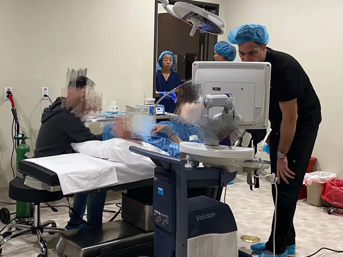 Surrogate receiving an ultrasound during embryo transfer monitoring