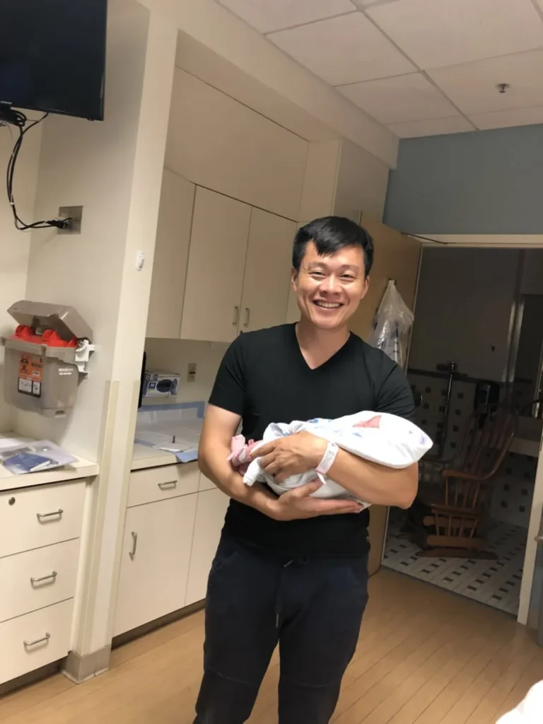 Intended parent with a newborn after a surrogacy journey