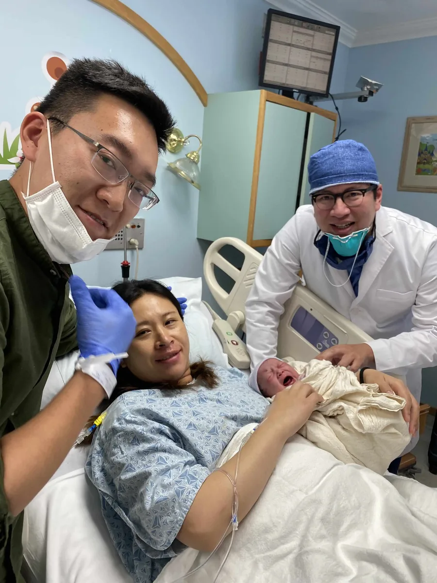 Surrogate supported by her medical team after delivery
