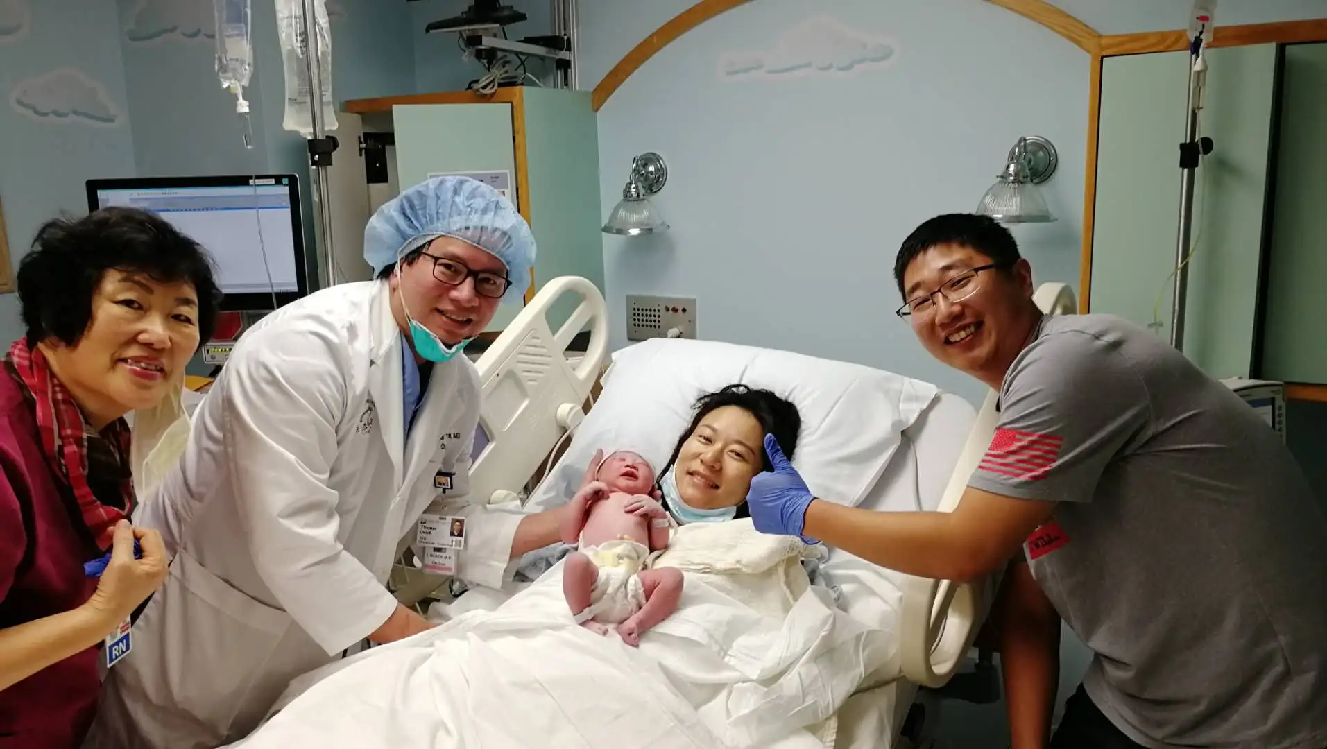 A surrogate supported by her medical and family care team after delivery