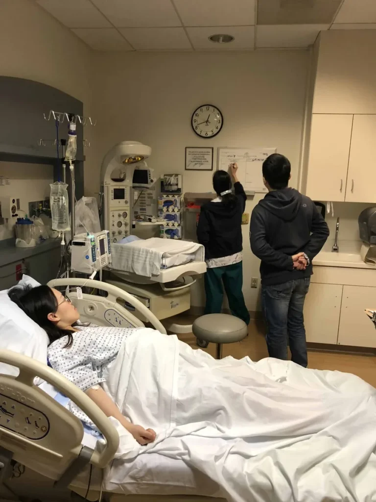 Surrogate receiving hospital care with medical monitoring