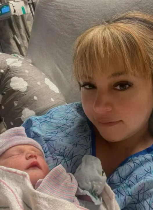 A surrogate sharing a joyful moment with a newborn